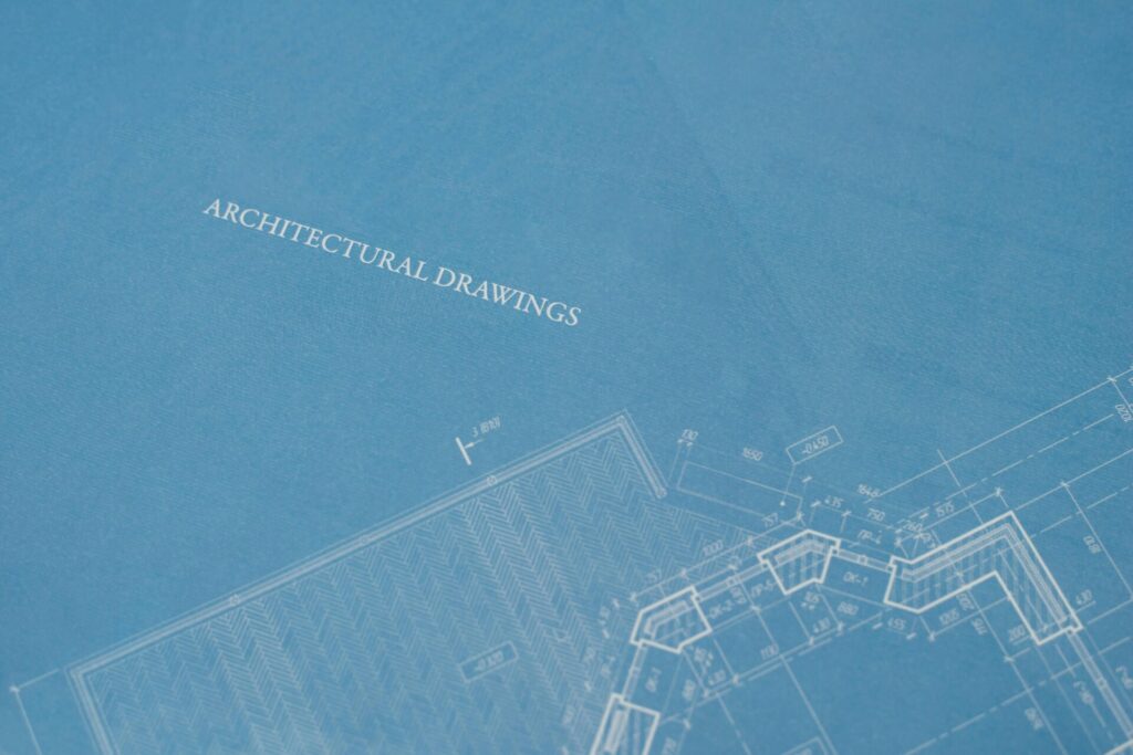 pexels-photo-4491829-4491829 - Steel Detailing Services - Steel Detailing Company Close-up view of architectural blueprint with technical drawings.